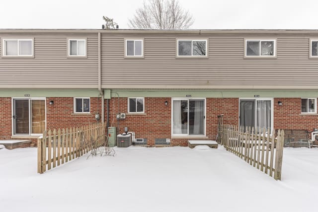 view of snow covered back of property