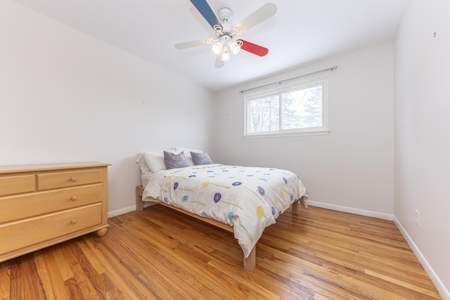 bedroom with ceiling fan and light hardwood / wood-style flooring