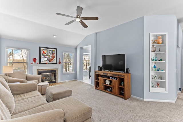 carpeted living room featuring ceiling fan, vaulted ceiling, and a wealth of natural light