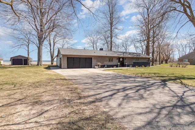 view of front of house with a front yard, driveway, and an attached garage