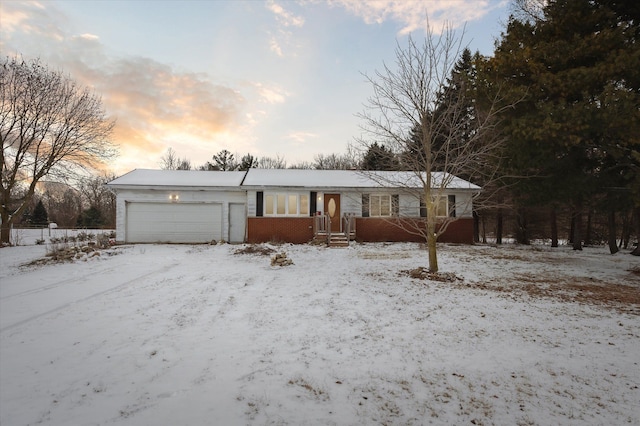 single story home with an attached garage and brick siding