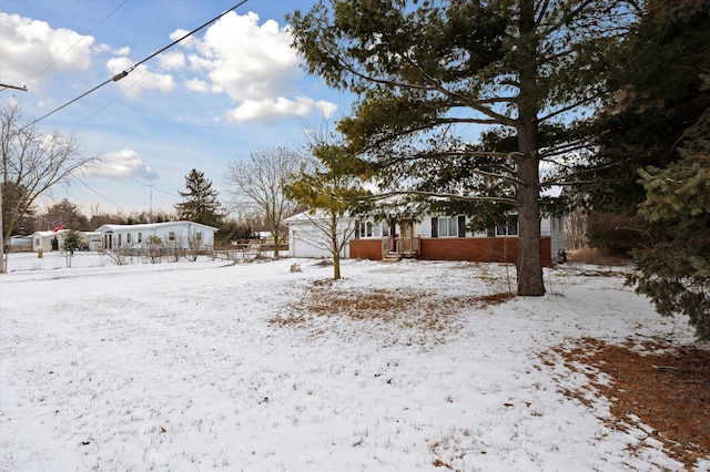 snowy yard featuring a garage