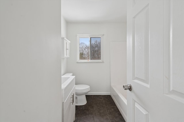 bathroom featuring baseboards, vanity, and toilet