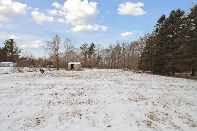 yard layered in snow featuring a garage