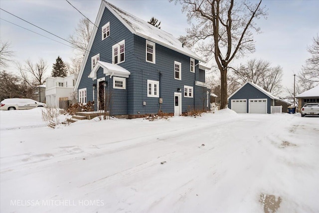 view of front of property featuring a garage and an outdoor structure