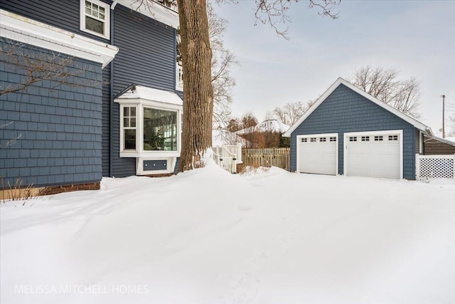 yard layered in snow with a garage