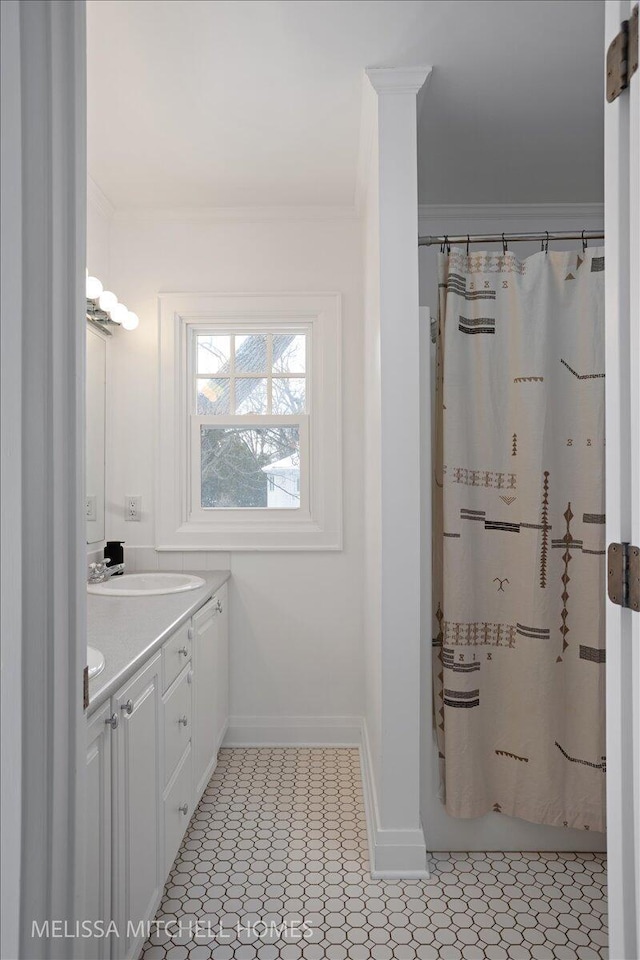 bathroom with vanity and ornamental molding