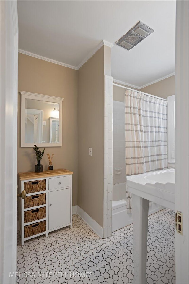 bathroom featuring shower / bath combo and crown molding