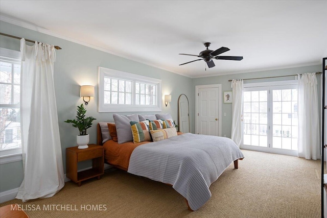 carpeted bedroom with ceiling fan, crown molding, and multiple windows