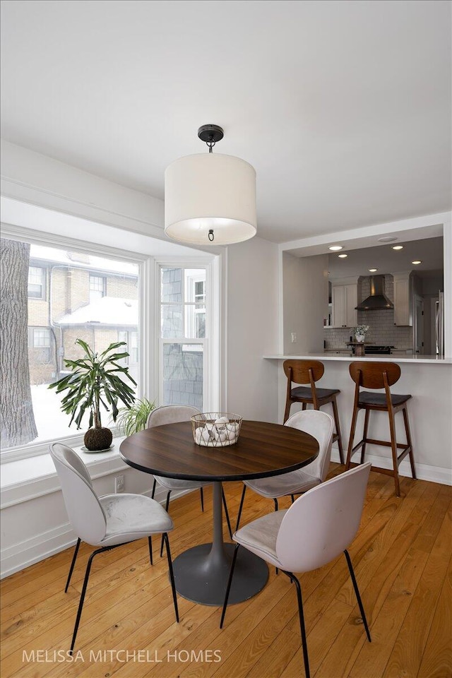 dining space featuring light wood-type flooring