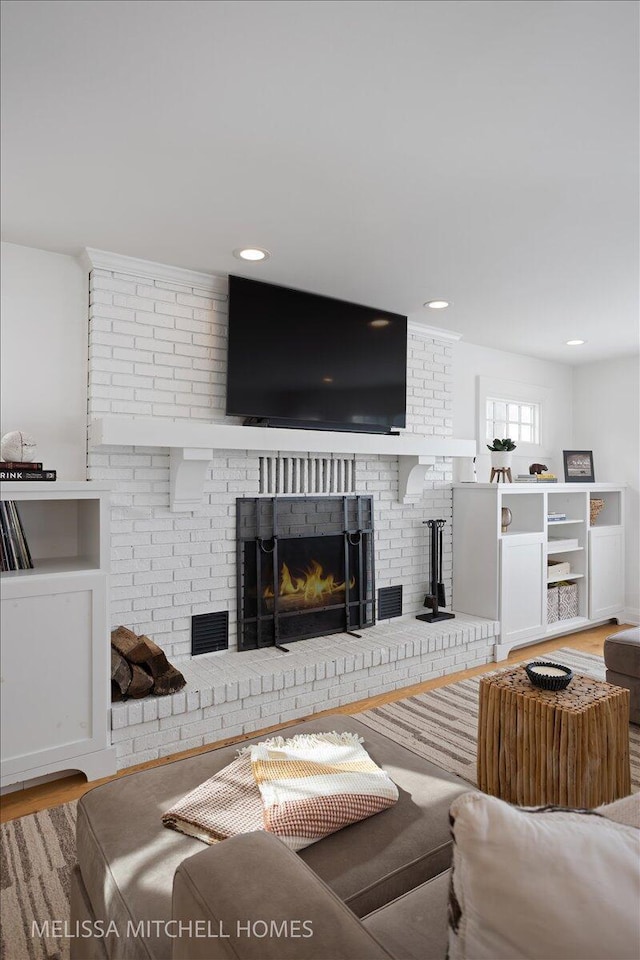 living room featuring a fireplace and hardwood / wood-style floors