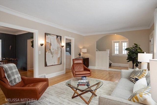 living room featuring light wood-type flooring and crown molding