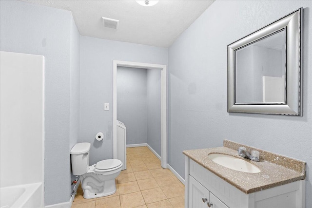 bathroom with a textured ceiling, toilet, vanity, and tile patterned flooring