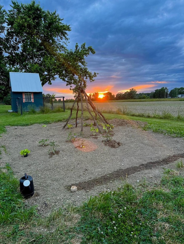 view of play area featuring an outbuilding and a rural view