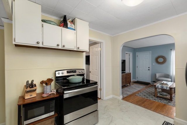 kitchen featuring white cabinetry, stainless steel electric range, and ornamental molding