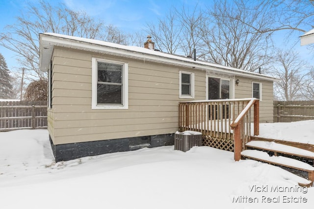 snow covered property with a wooden deck