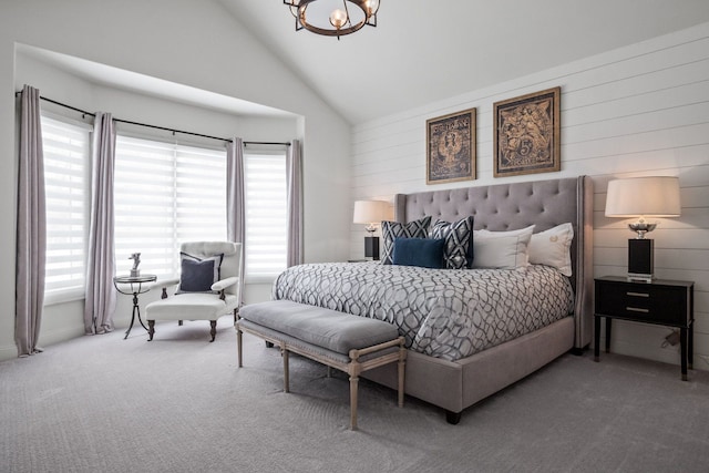 carpeted bedroom featuring lofted ceiling and a notable chandelier