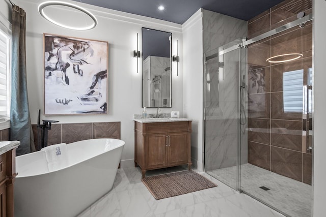 bathroom with marble finish floor, a soaking tub, a shower stall, and vanity