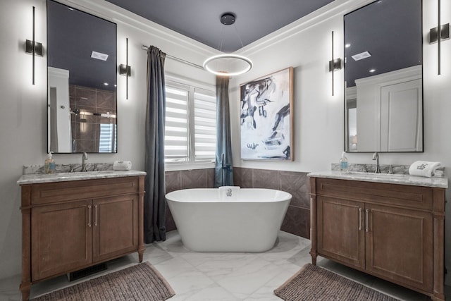 bathroom featuring a freestanding tub, visible vents, a sink, and marble finish floor