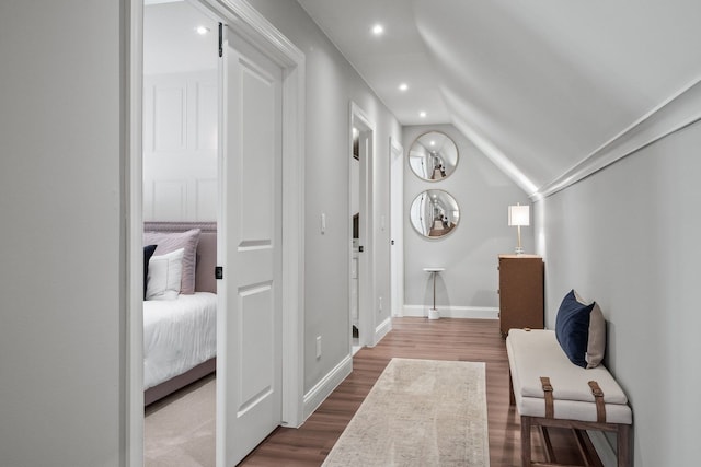 interior space with lofted ceiling, recessed lighting, dark wood finished floors, and baseboards