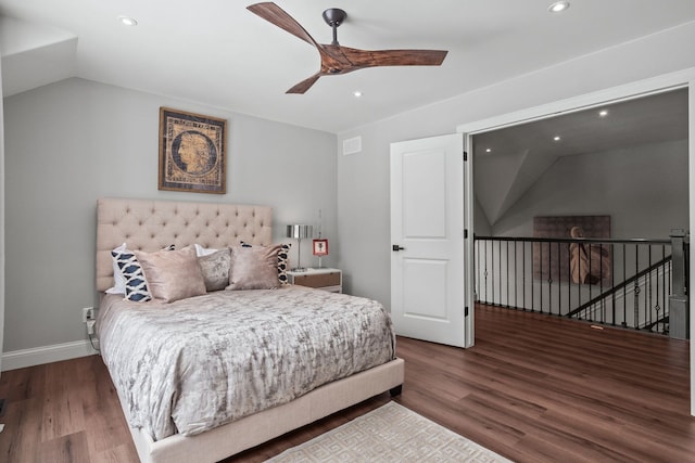 bedroom with vaulted ceiling, dark wood-style flooring, and recessed lighting