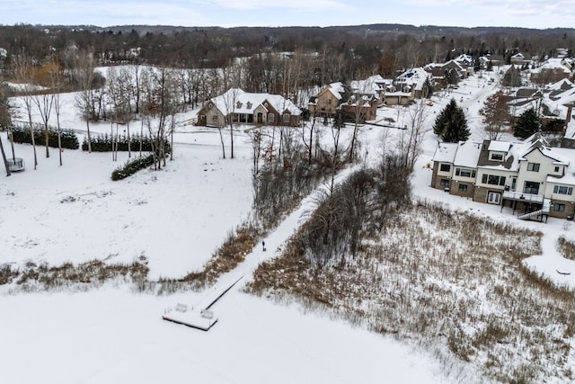 snowy aerial view with a residential view