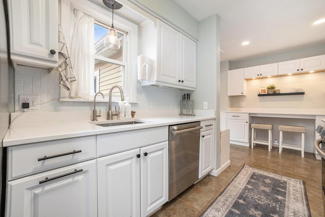 kitchen featuring dishwasher, pendant lighting, and white cabinetry