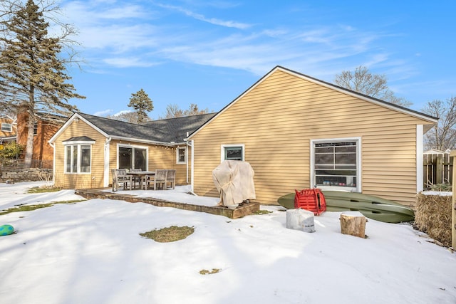 view of snow covered back of property