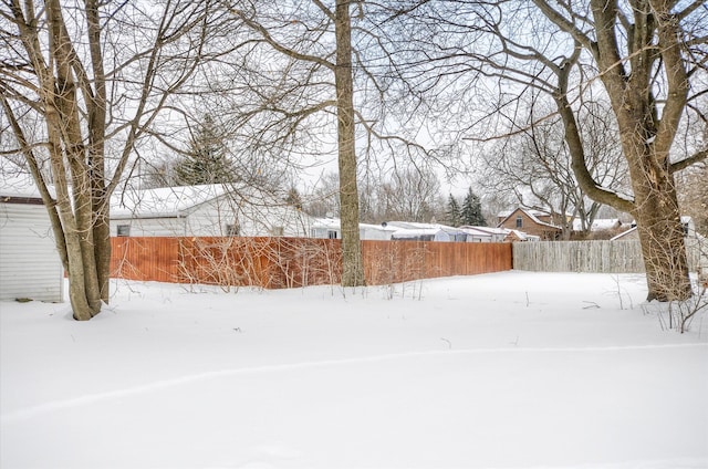 yard covered in snow with fence