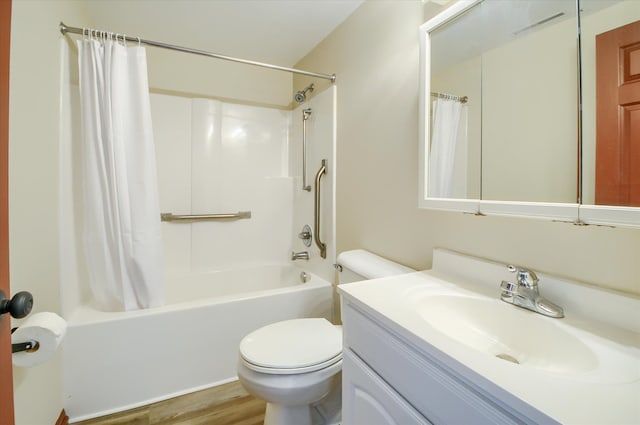 bathroom featuring visible vents, toilet, shower / bath combo, vanity, and wood finished floors