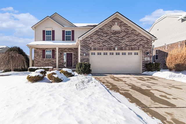 traditional-style house featuring an attached garage, driveway, and brick siding