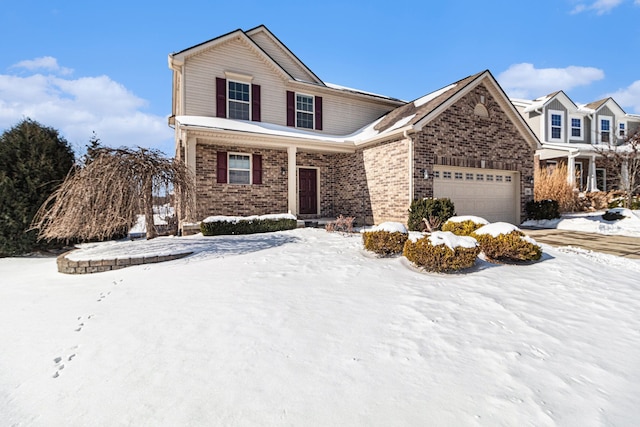 traditional-style home featuring brick siding and an attached garage