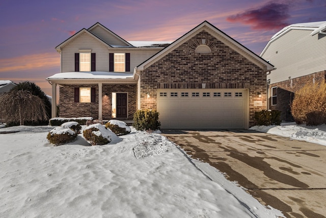 traditional home with driveway, brick siding, and an attached garage