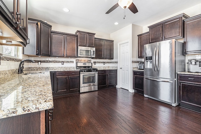 kitchen featuring dark brown cabinets, appliances with stainless steel finishes, and a sink