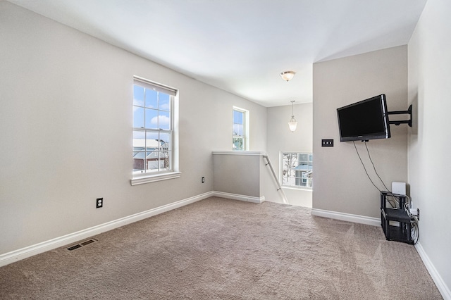 living room featuring carpet, visible vents, and baseboards