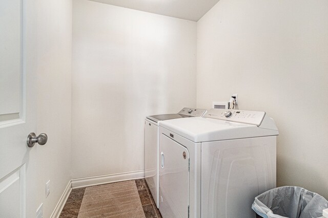 laundry room with laundry area, separate washer and dryer, and baseboards