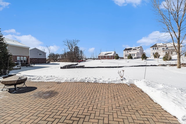 snow covered patio with a residential view