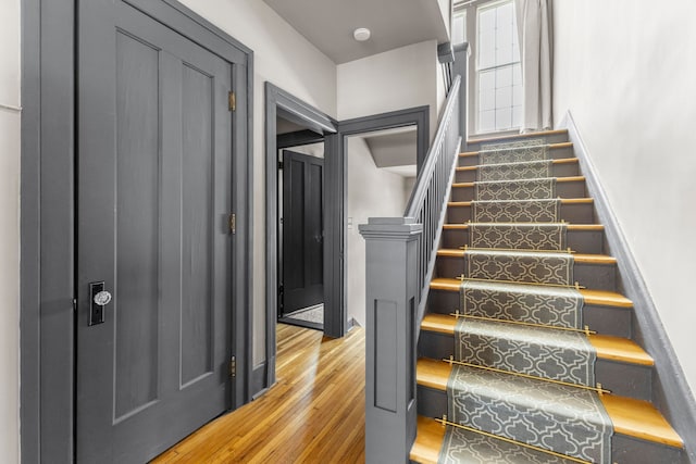 stairs featuring wood finished floors