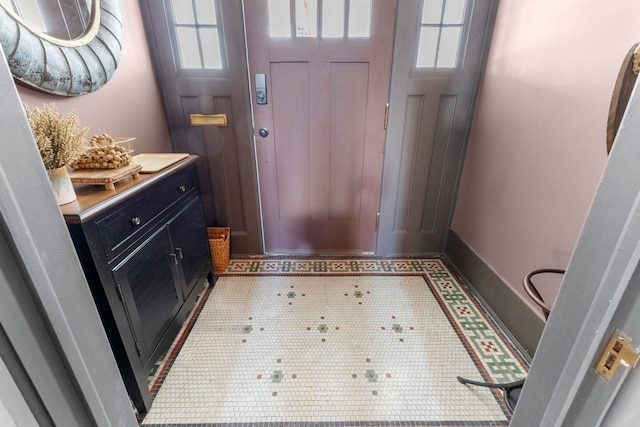 doorway with baseboards and a healthy amount of sunlight