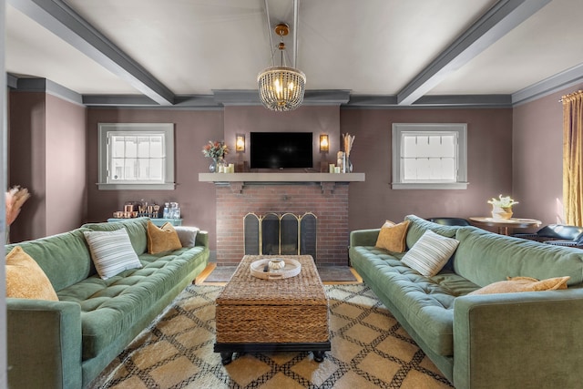 living area featuring crown molding, beam ceiling, a notable chandelier, and a fireplace