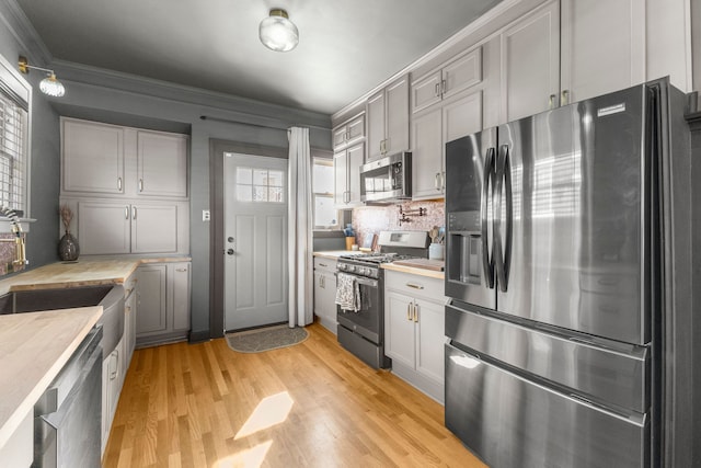 kitchen featuring appliances with stainless steel finishes, gray cabinets, and light countertops