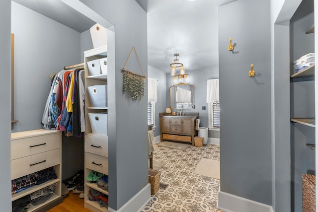 walk in closet featuring a sink