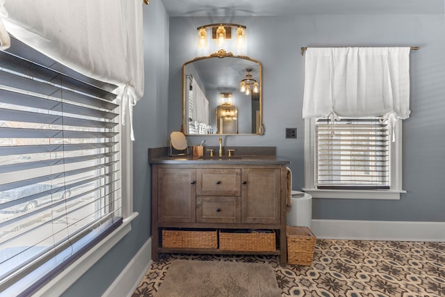 bathroom with vanity and baseboards