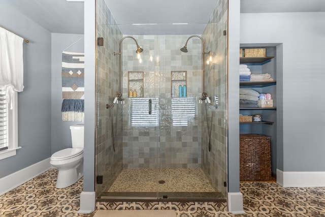 full bathroom with tile patterned floors, a shower stall, toilet, and baseboards