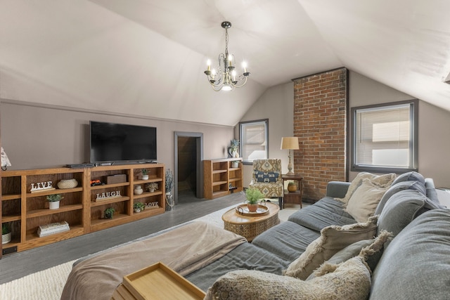 living room featuring vaulted ceiling, wood finished floors, a wealth of natural light, and an inviting chandelier