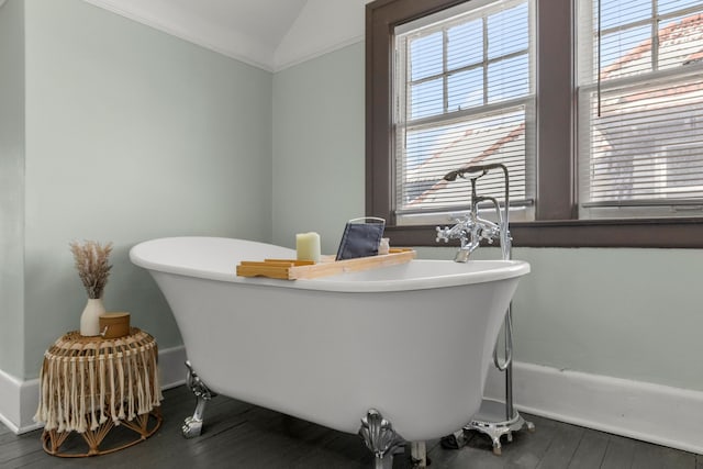 full bathroom featuring lofted ceiling, a freestanding bath, and wood finished floors