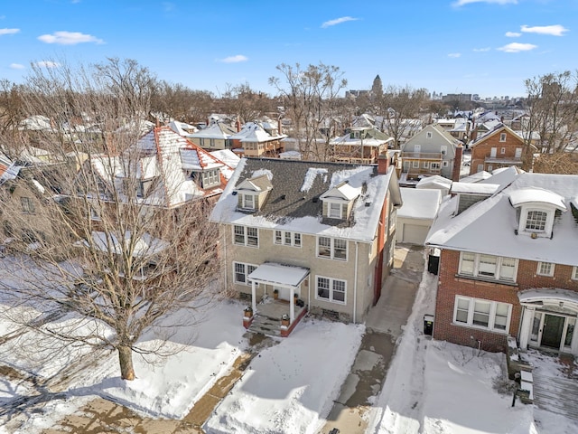 snowy aerial view featuring a residential view