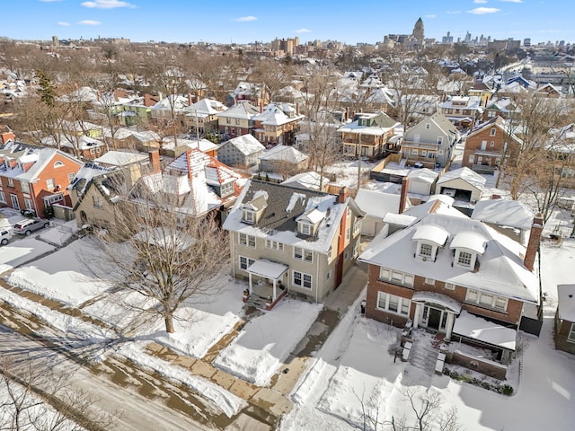 snowy aerial view with a residential view