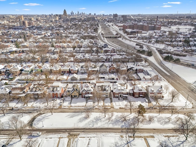 snowy aerial view featuring a residential view and a city view