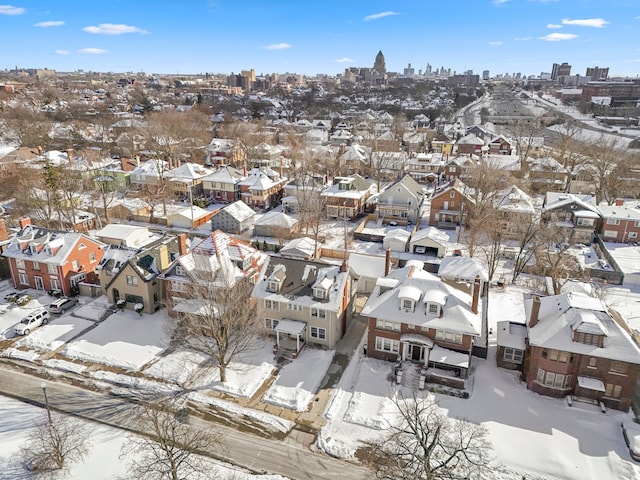 snowy aerial view with a residential view